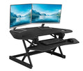 46" Height Adjustable Corner Standing Desk Converter with AC Outlet USB Charger and Dual Monitor Arm Mount Black B352